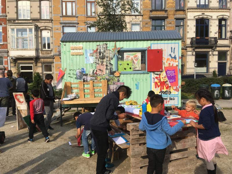 Enfants et jeunes réunis pour une caravane vert clair